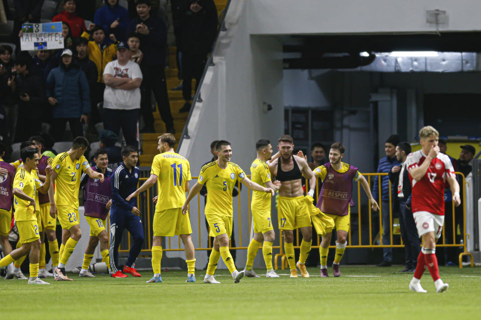 Kazakhstan's players celebrate their victory in the Euro 2024 group H qualifying soccer match between Kazakhstan and Denmark at the Astana Arena stadium in Astana, Kazakhstan, Sunday, March 26, 2023. (AP Photo)