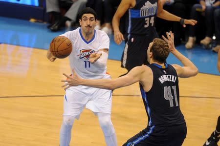 Apr 16, 2016; Oklahoma City, OK, USA; Oklahoma City Thunder center Enes Kanter (11) passes the ball defended by Dallas Mavericks forward Dirk Nowitzki (41) during the second quarter in game one of their first round NBA Playoff series at Chesapeake Energy Arena. Mandatory Credit: Mark D. Smith-USA TODAY Sports