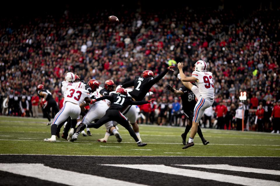 Cincinnati Bearcats linebacker Wilson Huber (2) gets a hand on Southern Methodist Mustangs place kicker Brendan Hall (93) punt in the first half of the NCAA football game between the Cincinnati Bearcats and the Southern Methodist Mustangs on Saturday, Nov. 20, 2021, at Nippert Stadium in Cincinnati.