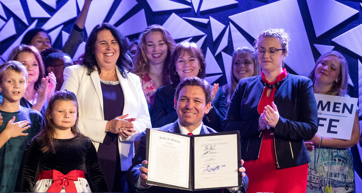 Gov. Ron DeSantis holds up the newly signed bill that will ban most abortions in Florida after 15 weeks at a news conference on April 14, 2022. (Willie J. Allen Jr/TNS via ZUMA Press Wire)