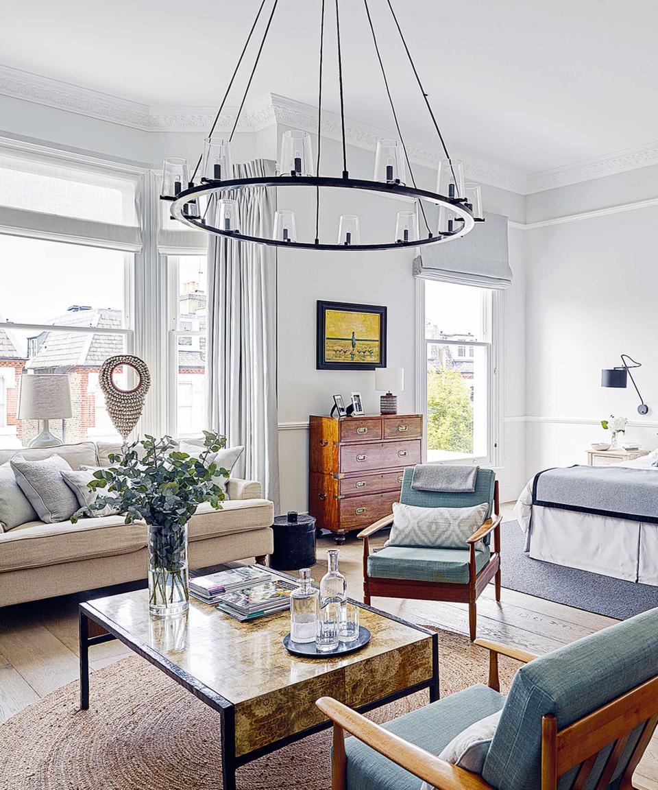 living room with armchairs, coffee table and large pendant light