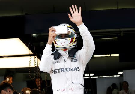 Formula One - F1 - Malaysia Grand Prix - Sepang, Malaysia- 30/9/16 Mercedes' Lewis Hamilton of Britain waves to his fans as he takes a photo after second practice. REUTERS/Edgar Su