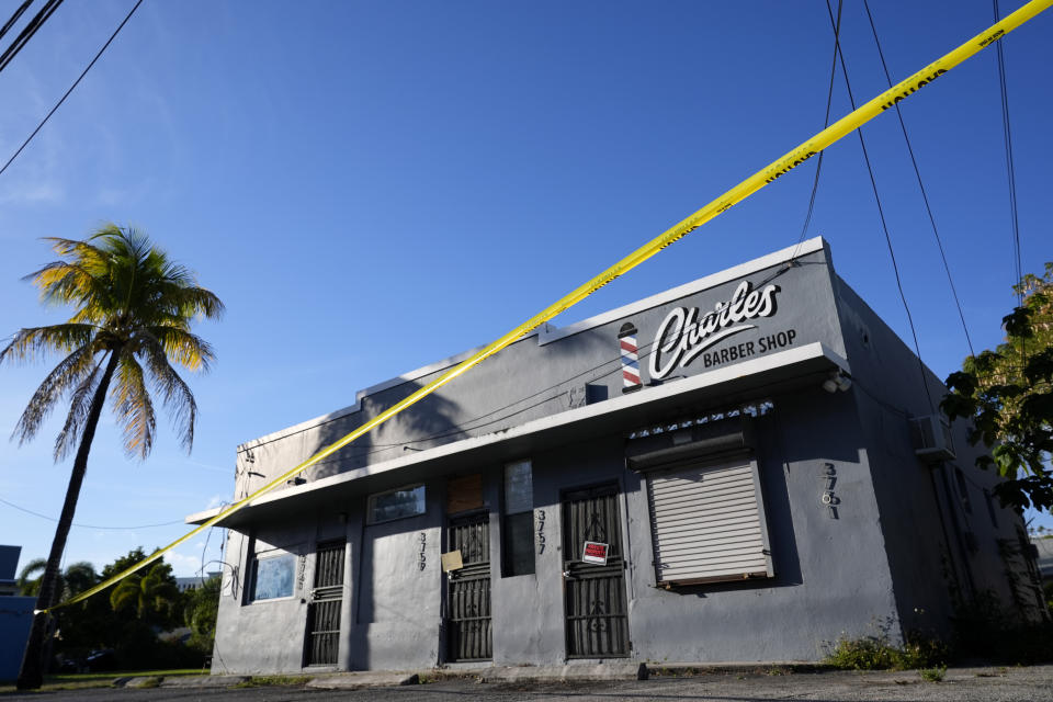 A building with a local barbershop is cordoned off before being torn down in the Miami neighborhood of west Coconut Grove, Thursday, Feb. 15, 2024. Historically Black west Coconut Grove is a majority Black neighborhood hidden among some of the most affluent areas in Miami that once boomed with sports and economics. Today, few remnants of that proud Black heritage exist. . (AP Photo/Lynne Sladky)
