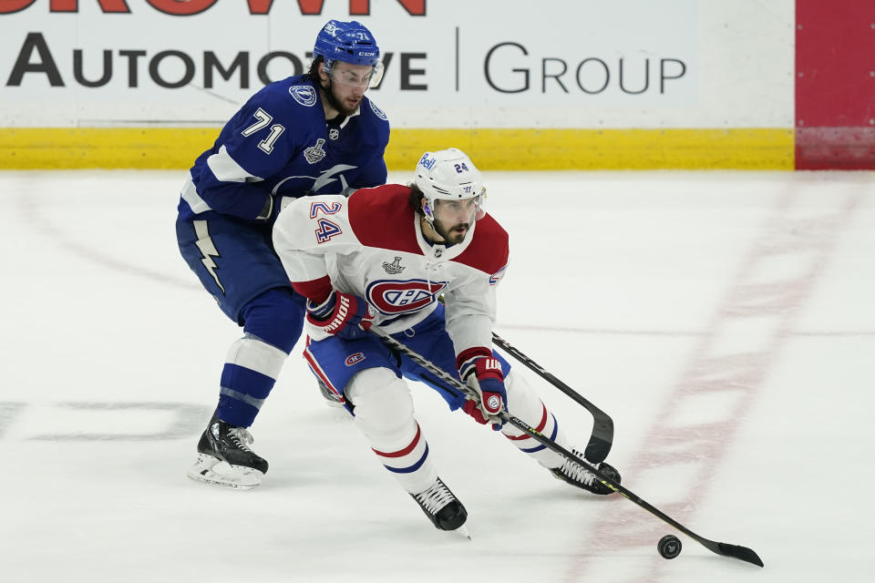 Montreal Canadiens left wing Phillip Danault (24) controls the puck next to Tampa Bay Lightning center Anthony Cirelli (71) during the second period in Game 2 of the NHL hockey Stanley Cup finals, Wednesday, June 30, 2021, in Tampa, Fla. (AP Photo/Gerry Broome)