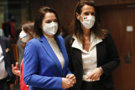 Belgian Foreign Minister Sophie Wilmes, right, and Belarusian opposition politician Sviatlana Tsikhanouskaya pose for a photo during a European Foreign Affairs Ministers meeting at the European Council building in Luxembourg, Monday, June 21, 2021. EU foreign ministers were set to approve Monday a new set of sanctions against scores of officials in Belarus and prepare a series of measures aimed at the country's economy. (Johanna Geron/Pool Photo via AP)