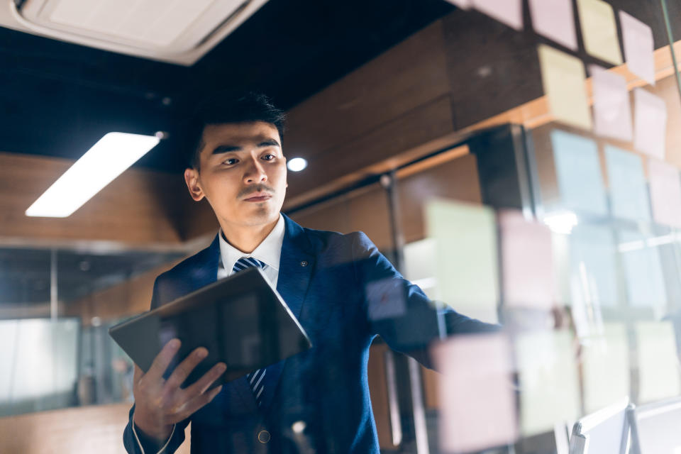 asian businessman brainstorming with digital tablet