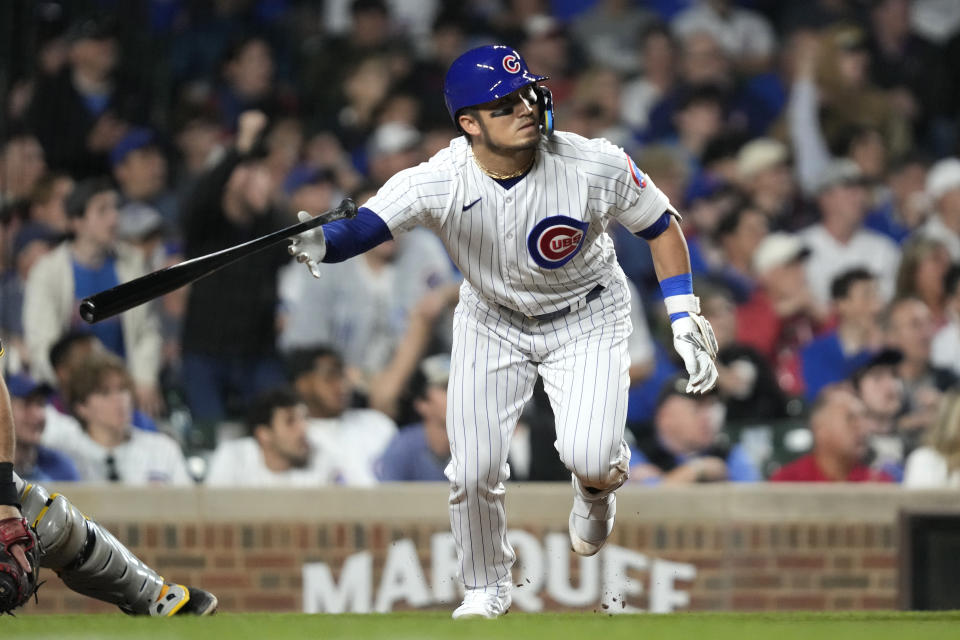 Chicago Cubs' Seiya Suzuki tosses his bat after hitting a two-run double off Pittsburgh Pirates relief pitcher Colin Holderman during the eighth inning of a baseball game Wednesday, June 14, 2023, in Chicago. (AP Photo/Charles Rex Arbogast)