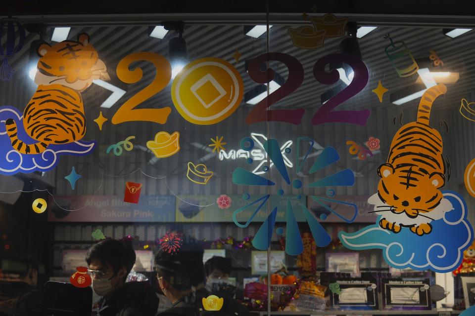 Chinese lunar new year decoration is seen at a store in Hong Kong, Friday, Jan. 14, 2022. Hong Kong International Airport said Friday that it would ban passengers from over 150 countries and territories from transiting in the city for a month, as it sought to stem the transmission of the highly contagious omicron variant of the coronavirus. (AP Photo/Kin Cheung)