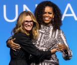 Julia Roberts and Michelle Obama embrace after an Obama Foundation event in Kuala Lumpur, Malaysia, on Thursday.