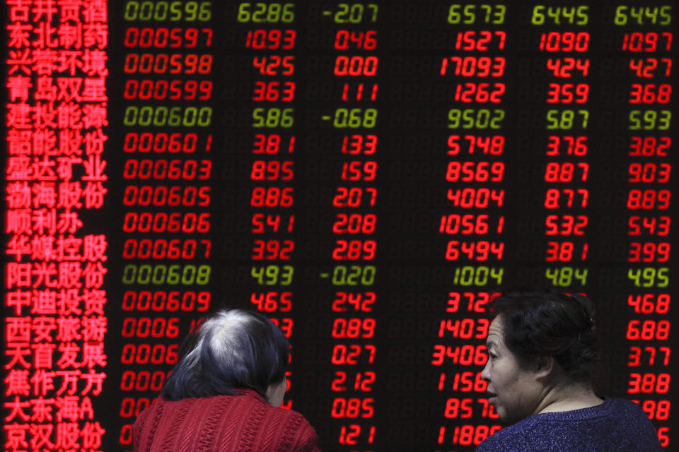 Women chat as they monitor stock prices at a brokerage house in Beijing, Friday, Feb. 1, 2019. Asian markets were mixed on Friday as trade talks ended in Washington with no deal but the promise of a second meeting between U.S. President Donald Trump and Chinese leader Xi Jinping. Gains were limited by a private survey showing that Chinese manufacturing slowed to the lowest level in almost three years. (AP Photo/Andy Wong)