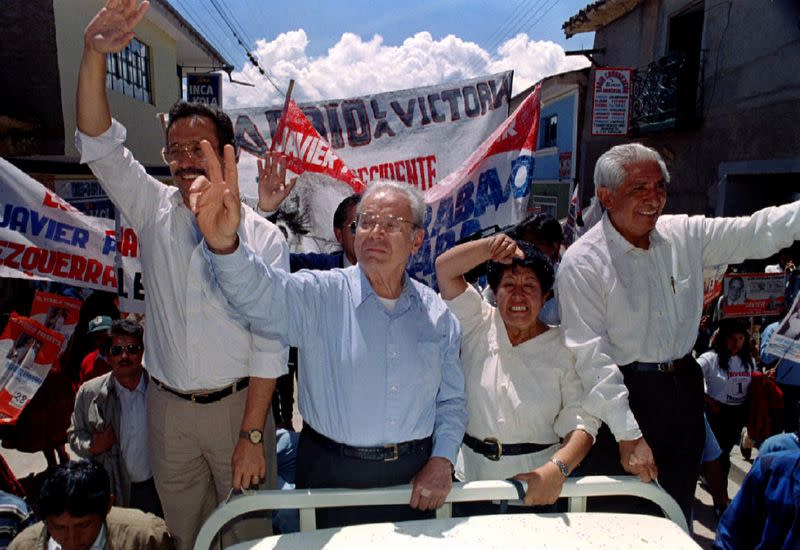 FILE PHOTO: Former United Nations Secretary General and presidential candidate Javier Perez de Cuellar (second from left) arrives in Sicuani