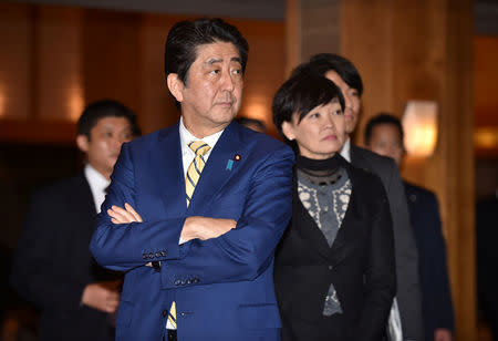 Japanese Prime Minister Shinzo Abe (C) and his wife Akie (R) wait for Russian President Vladimir Putin's arrival at a hotel prior to their talks in Nagato, Yamaguchi prefecture on December 15, 2016. REUTERS/ Kazuhiro Nogi/Pool
