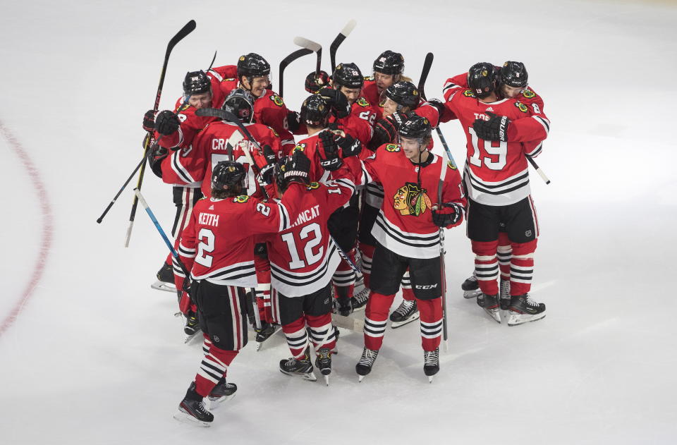 Chicago Blackhawks players celebrate their win over the Edmonton Oilers in an NHL hockey playoff game Friday, Aug. 7, 2020, in Edmonton, Alberta. (Jason Franson/Canadian Press via AP)