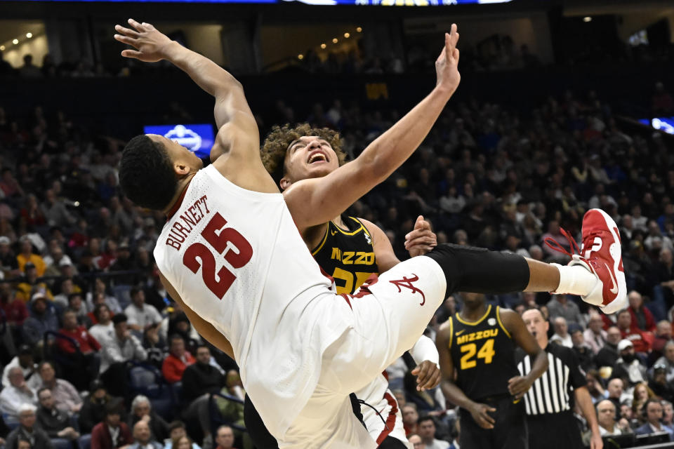 Alabama guard Nimari Burnett (25) and Missouri forward Noah Carter vie for a rebound during the first half of an NCAA college basketball game in the semifinals of the Southeastern Conference Tournament, Saturday, March 11, 2023, in Nashville, Tenn. (AP Photo/John Amis)