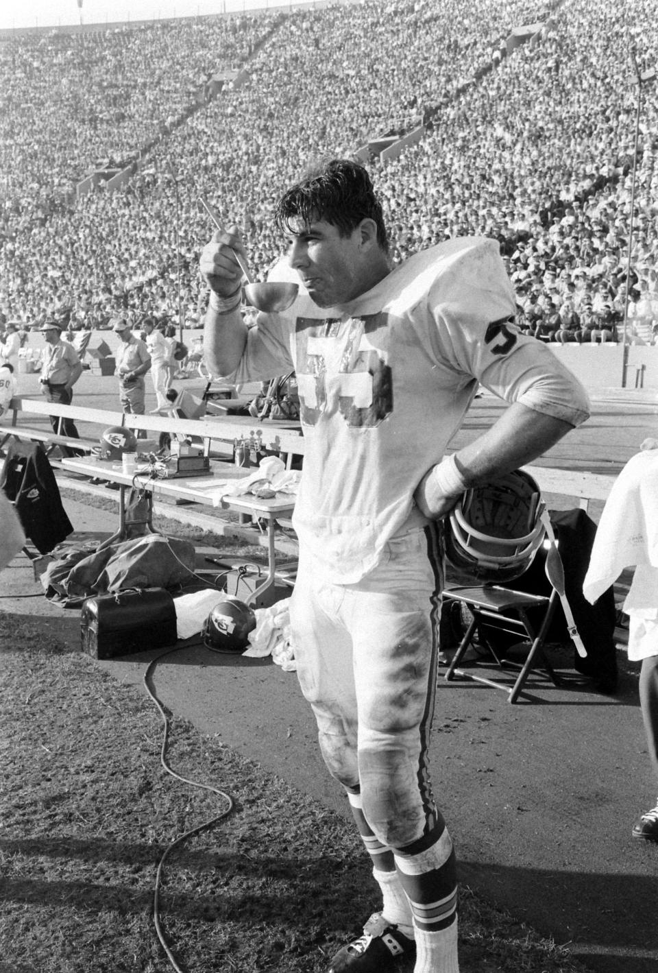 Chiefs linebacker E. J. Holub drinks from a ladle on the sidelines. <span class="copyright">Bill Ray—The LIFE Picture Collection/Shutterstock</span>