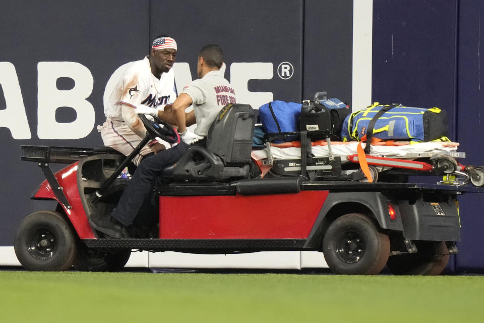 Miami Marlins center fielder Jonathan Davis leaves the field on a cart after an injury during the fifth inning of a baseball game against the St. Louis Cardinals, Tuesday, July 4, 2023, in Miami. (AP Photo/Lynne Sladky)