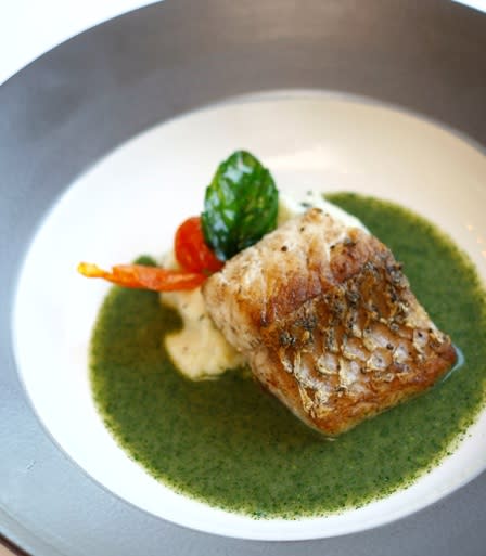 Filleto di Barramundi Spadellato: Compose the plate with a quenelle of basil mashed potatoes, then the parsley broth and barramundi and garnish with a fried cherry tomato.