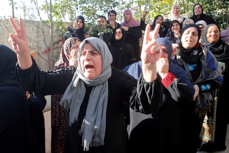 Relative of Palestinian man Omar al-Badawi reacts during his funeral in al-Arroub refugee camp, in the Israeli-occupied West Bank