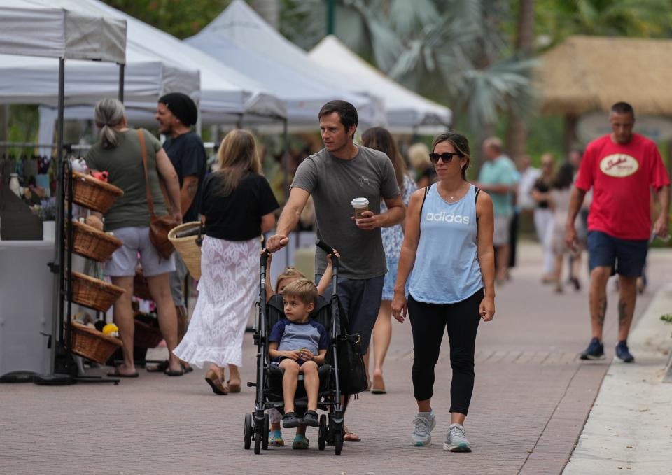 A family is pictured at the Waterfront Market at Harbourside Place in Jupiter. The market is open Sundays from Oct. 2 through May 2024.