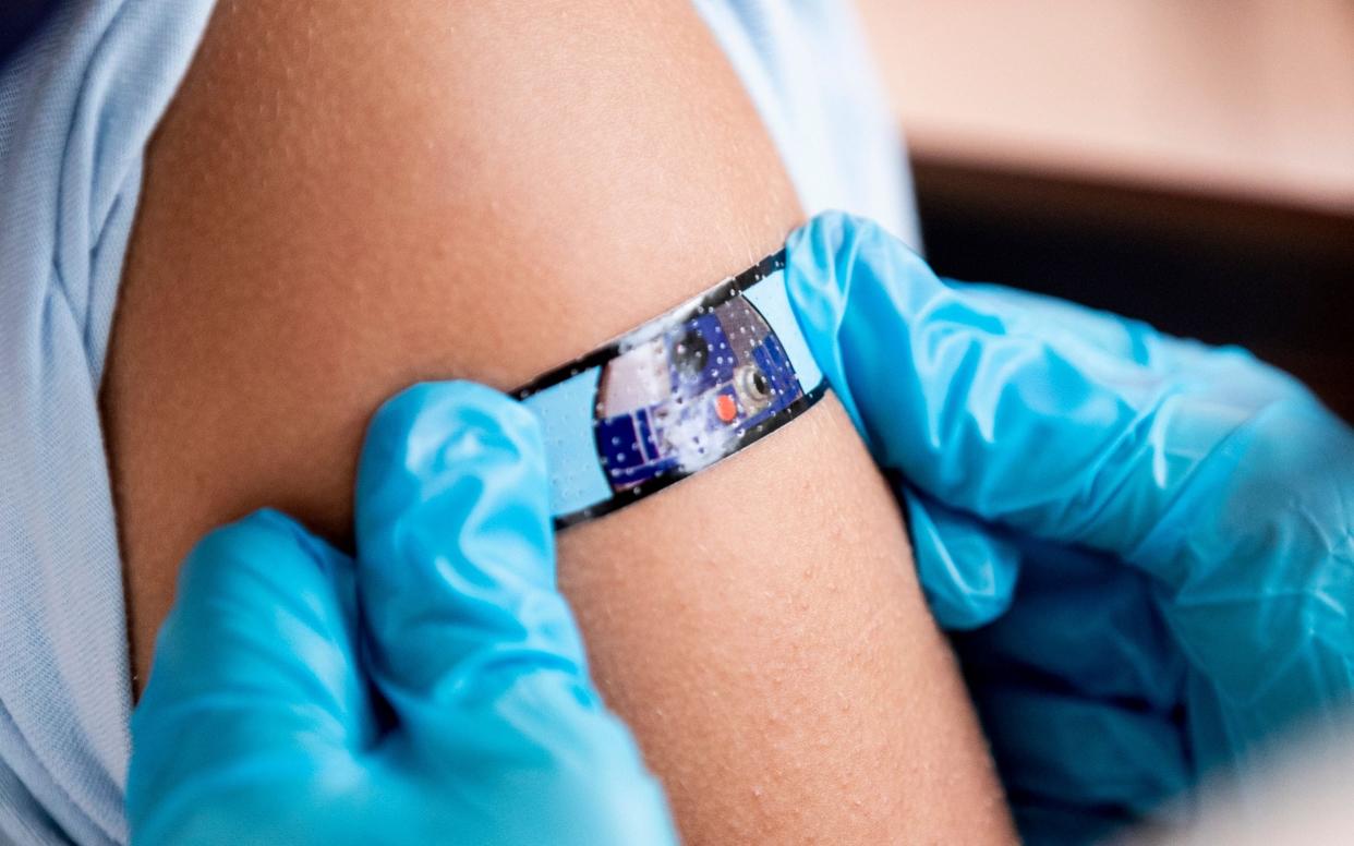 A Star Wars bandage is applied on a 12-year-old girl's arm after she received a Covid vaccine in California this month - ETIENNE LAURENT/EPA-EFE/Shutterstock