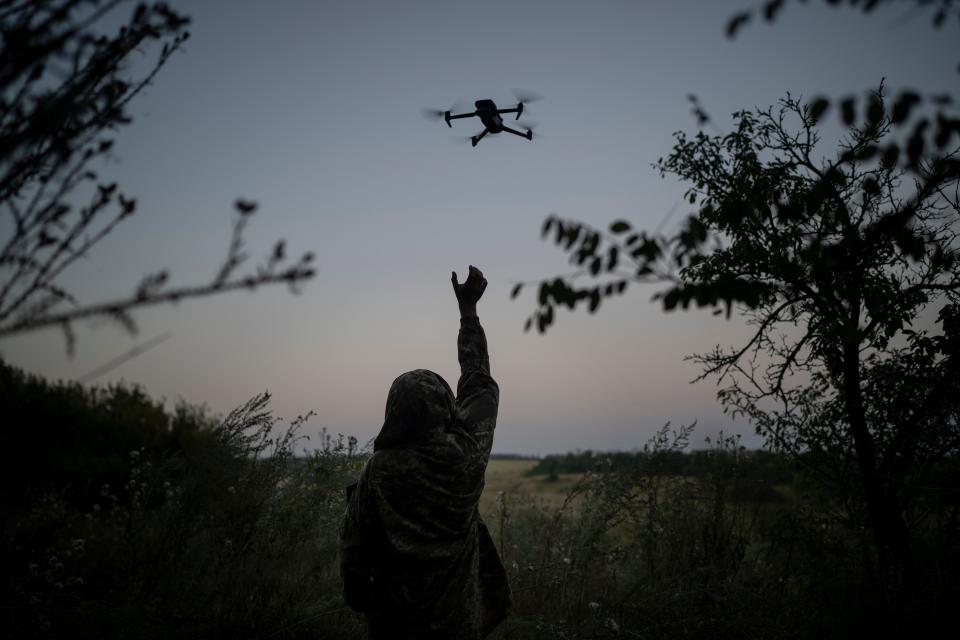 A Ukrainian drone pilot reaches for a reconnaissance drone in the Luhansk Region, Ukraine, Saturday, Aug. 19, 2023.