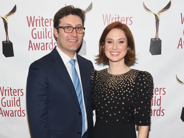 Nicholas Hunt/Getty Michael Koman and Ellie Kemper pose backstage during the 71st Annual Writers Guild Awards New York ceremony in New York City in February 2019.