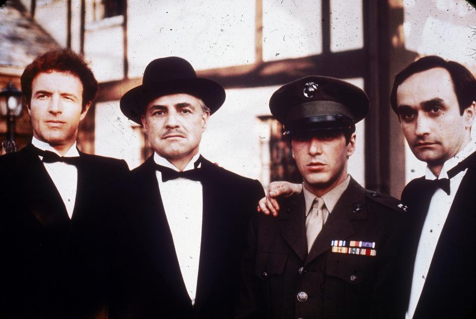 1972:  Left to right: American actors James Caan, Marlon Brando, Al Pacino and John Cazale (1936 - 1978) pose together outdoors in a still from director Francis Ford Coppola's film, 'The Godfather,'  based on the novel by Mario Puzo.  (Photo by Paramount Pictures/Fotos International/Getty Images)