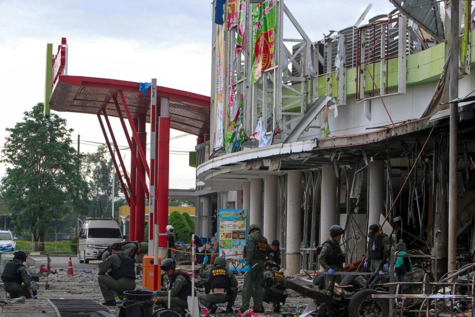 Military personnel inspect the site of a bomb attack in Pattani