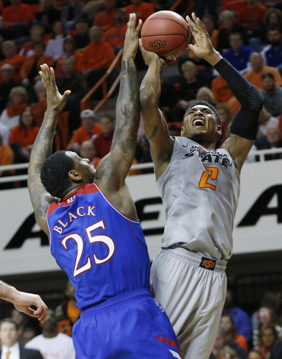 Oklahoma State wing Le'Bryan Nash (2) shoots in front of Kansas forward Tarik Black (25) during the second half of an NCAA college basketball game in Stillwater, Okla., Saturday, March 1, 2014. Oklahoma State won 72-65. (AP Photo/Sue Ogrocki)