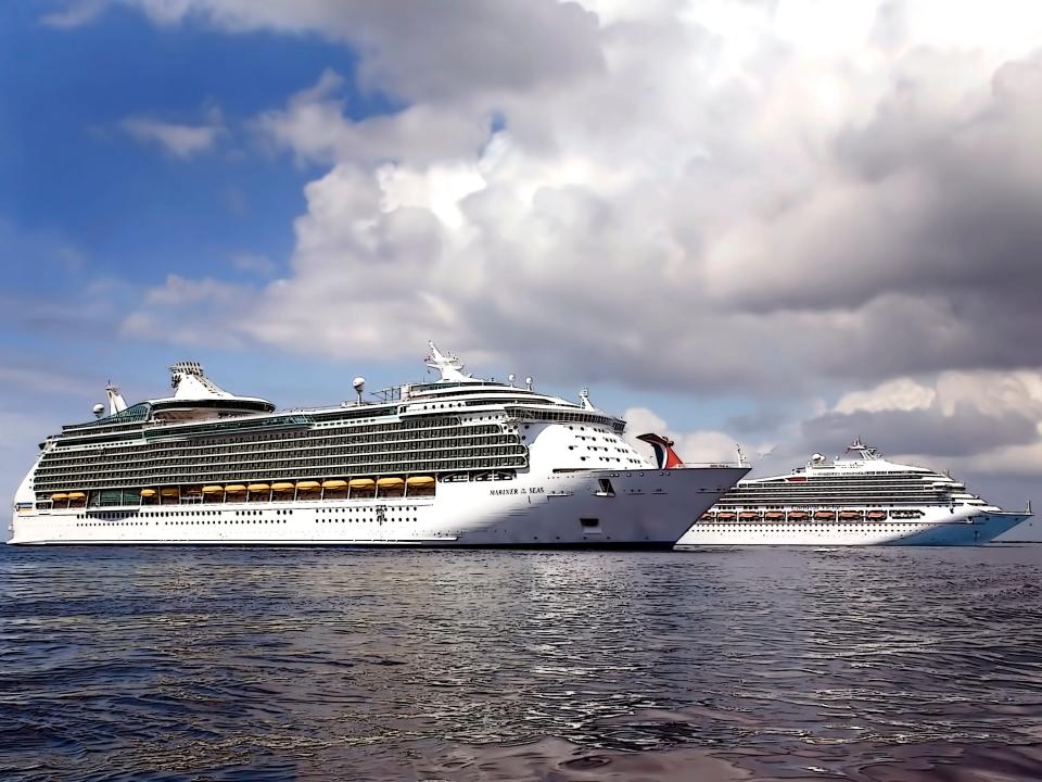 Royal Caribbean's Mariner of the Sea and a Carnival Cruise ship anchored off the shore of Grand Cayman Island.