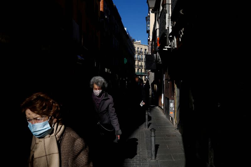 FILE PHOTO: Elderly women wearing face masks walk along a street amid the coronavirus disease (COVID-19) pandemic in Madrid