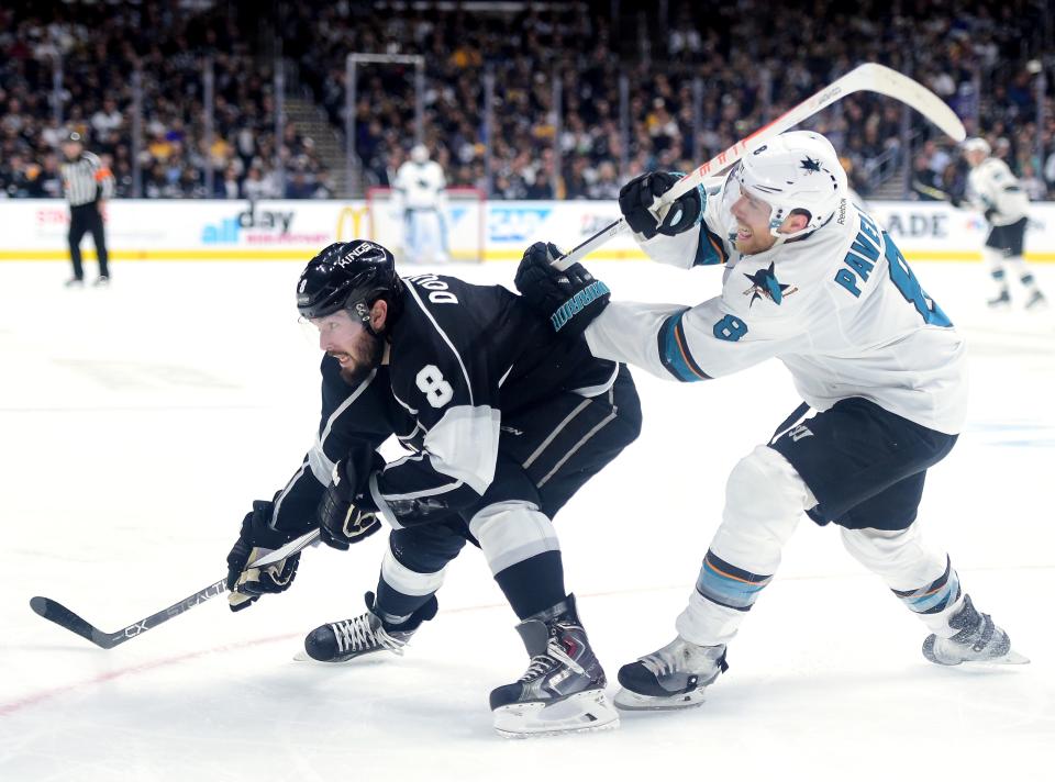 LOS ANGELES, CA - APRIL 16:  Drew Doughty #8 of the Los Angeles Kings fends off Joe Pavelski #8 of the San Jose Sharks on the way to the puck in Game One of the Western Conference Quarterfinals during the 2015 NHL Stanley Cup Playoffs at Staples Center on April 16, 2016 in Los Angeles, California.  (Photo by Harry How/Getty Images)