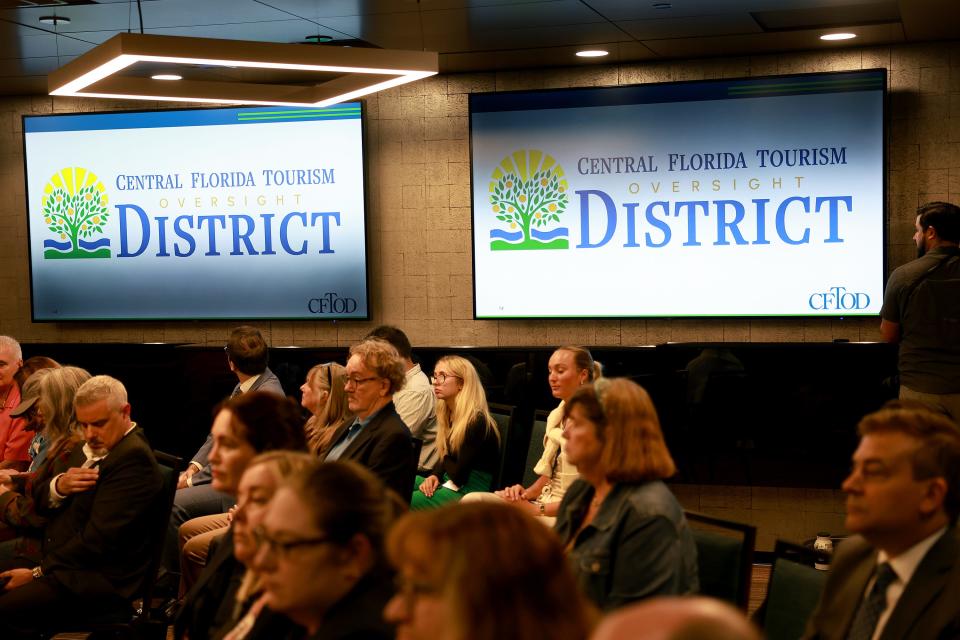A screen shows the newly reveled logo for the Central Florida Tourism Oversight District, formerly known as the Reedy Creek Improvement District, at the center of the Disney-DeSantis-feud.