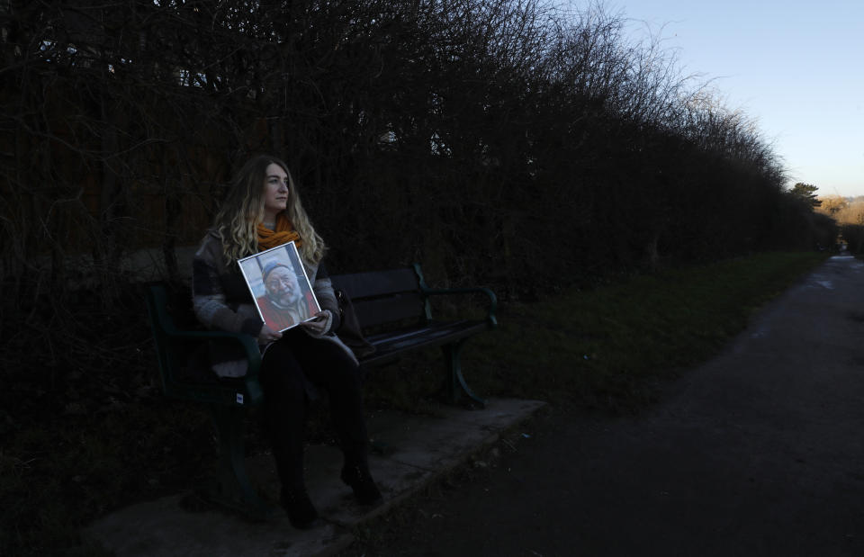 Jo Goodman holds a portrait of her late father Stuart as she poses for a photo in London, Friday, Jan. 22, 2021. Jo's father Stuart died of COVID-19, in April 2020. A couple of months after her father died, Goodman, 32, co-founded the COVID-19 Bereaved Families for Justice group to pressure the government to back a public inquiry into how the pandemic was handled last spring. (AP Photo/Alastair Grant)