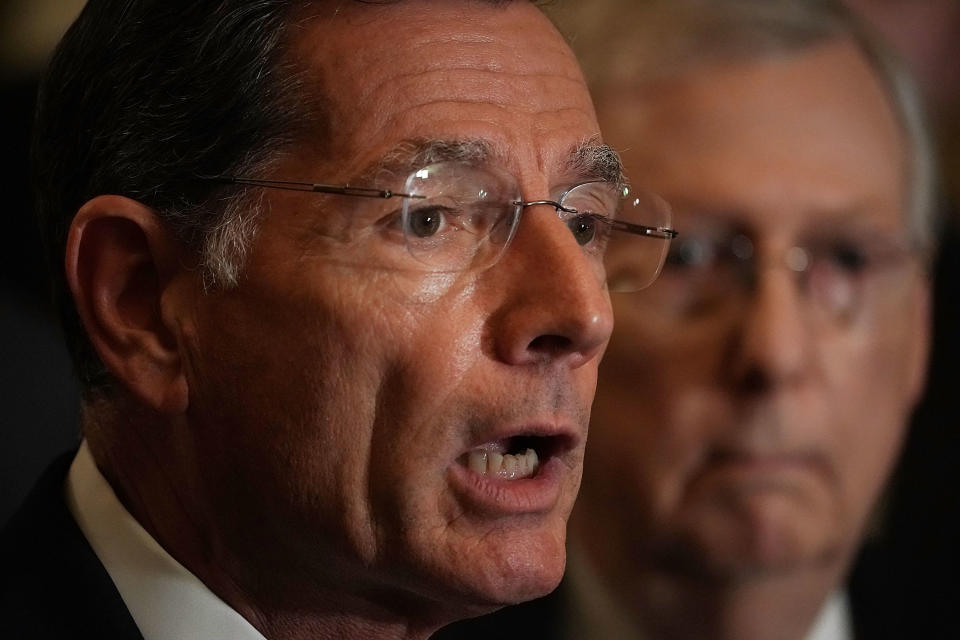 Sen. John Barrasso, R-Wyo., speaks as Senate Majority Leader Mitch McConnell, R-Ky., listens during a news briefing at the U.S. Capitol. (Photo: Alex Wong/Getty Images)