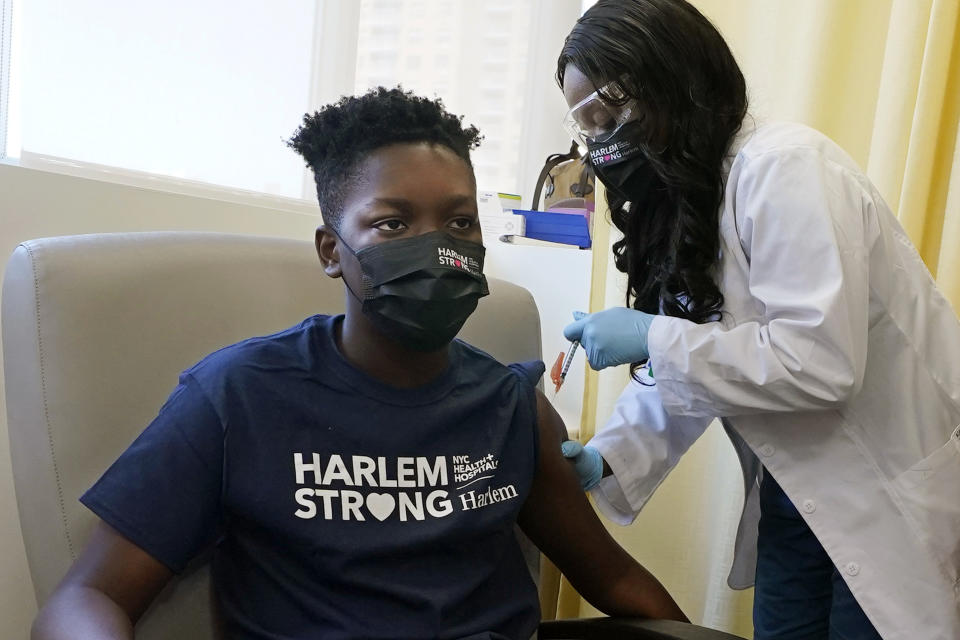 Julian Boyce, 14, receives his first Pfizer COVID-19 vaccination at NYC Health + Hospitals/Harlem, from nurse Kenia Georges in New York, Thursday, May 13, 2021. New York Gov. Andrew Cuomo announced Wednesday that children between the ages of 12 and 15 can get vaccinated in New York effective immediately. (AP Photo/Richard Drew)