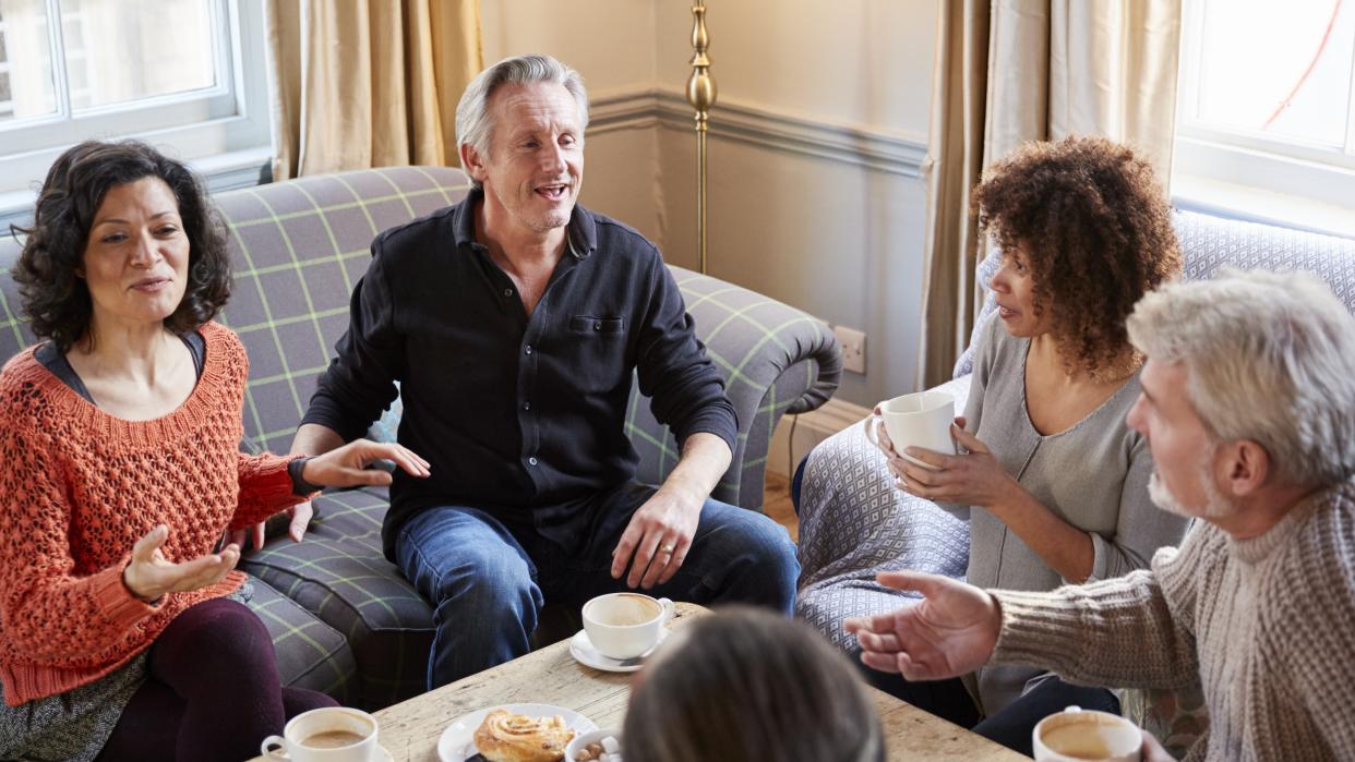  Four people sitting in a cafe. 