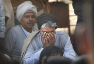 Indian Farmers listen to their leader as they continue to block highway leading to Delhi against new farm laws, at Delhi-Uttar Pradesh border, India, Friday, Jan. 22, 2021. Talks between protesting farmers’ leaders and the government ended abruptly in a stalemate on Friday with the agriculture minister saying he has nothing more to offer than suspending contentious agricultural laws for 18 months. The farmers’ organizations in a statement on Thursday said they can’t accept anything except the repeal of the three new laws. (AP Photo/Manish Swarup)
