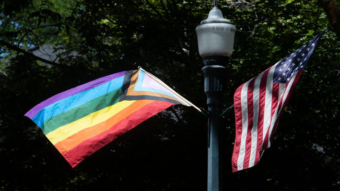 A Progressive Pride flag flies next to an American flag on from a streetlamp on Harrison Blvd. at Ada Street in Boise on Friday, June 18, 2021. Several of the rainbow flags that represent lesbian, gay, bisexual, transgender, and queer (LGBT) pride have been stolen.