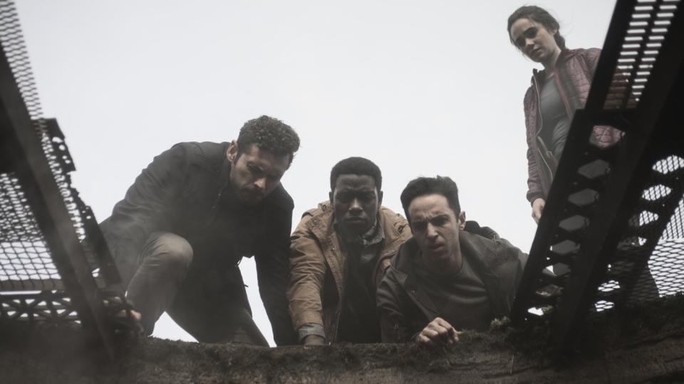 Adan Canto, Chinaza Uche, Zach Avery and Alicia Sanz peer into a mine in the movie "The Devil Below."