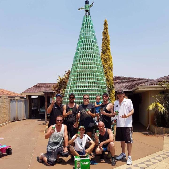 Wesley Boyd and his friends pose with their beer can Christmas tree creation. Photo from Facebook.