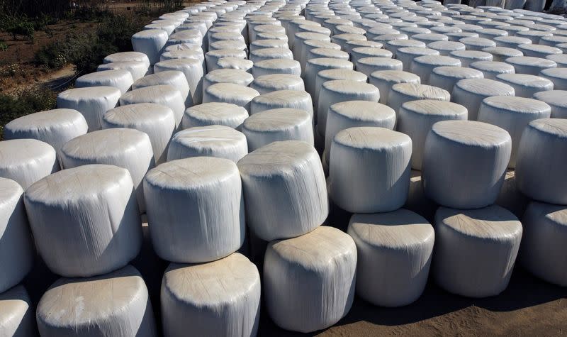 Animal feed bulk bags are stacked outside a farm on the island of Naxos