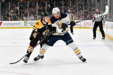 Dec 16, 2018; Boston, MA, USA; Boston Bruins defenseman Charlie McAvoy (73) checks Buffalo Sabres left wing Jeff Skinner (53) during the third period at the TD Garden. Mandatory Credit: Brian Fluharty-USA TODAY Sports