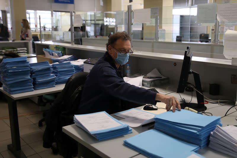 An employee works at a Greek Manpower Employment Organisation (OAED) office near Athens