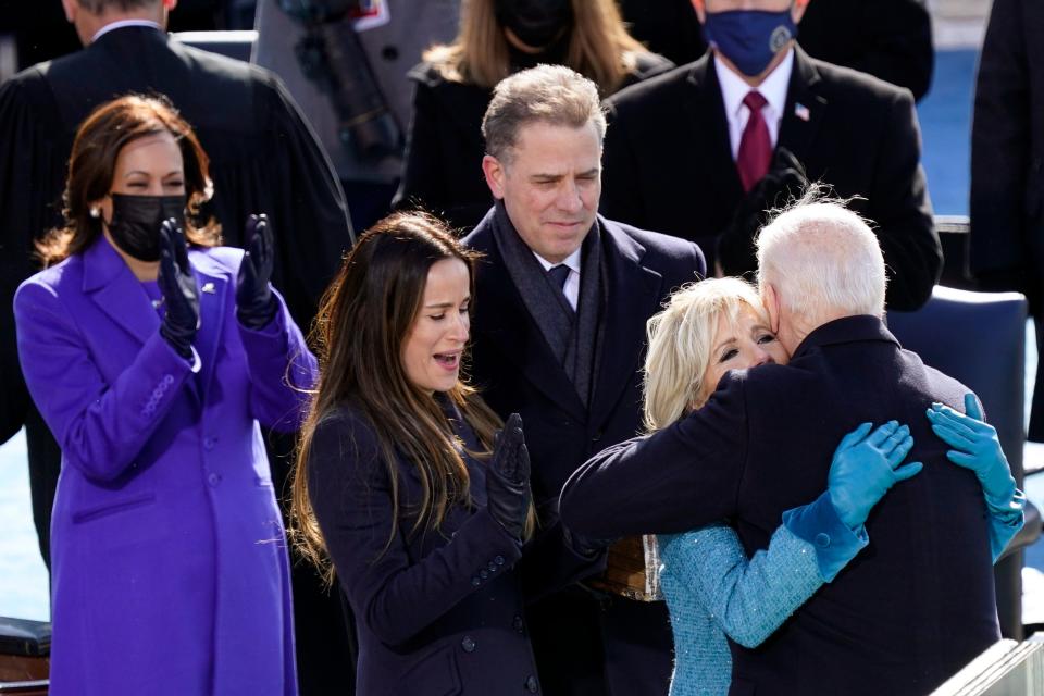 In this Wednesday, Jan. 20, 2021, file photo, President Joe Biden hugs first lady Jill Biden, as his son Hunter Biden and daughter Ashley Biden look on after the president was sworn-in during the 59th presidential inauguration at the U.S. Capitol in Washington. Vice President Kamala Harris applauds, at left. Hunter Biden says his service on the board of a Ukrainian gas company wasn't unethical and didn't amount to a lack of judgment on his part.