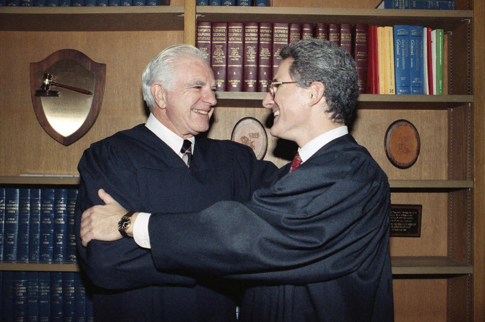 <p> FILE - In this Friday, Oct. 13, 1989, file photo, retired Judge Joseph A. Wapner of TV's 'The People's Court' congratulates his son, Judge Frederick N. Wapner, right, as he was enrobed as a Municipal Court judge in Los Angeles. Wapner, who presided over "The People's Court" with steady force during the heyday of the reality courtroom show, has died. Wapner died at home in his sleep Sunday, Feb. 26, 2017, according to his son, David Wapner. (AP Photo/Nick Ut, File) </p>