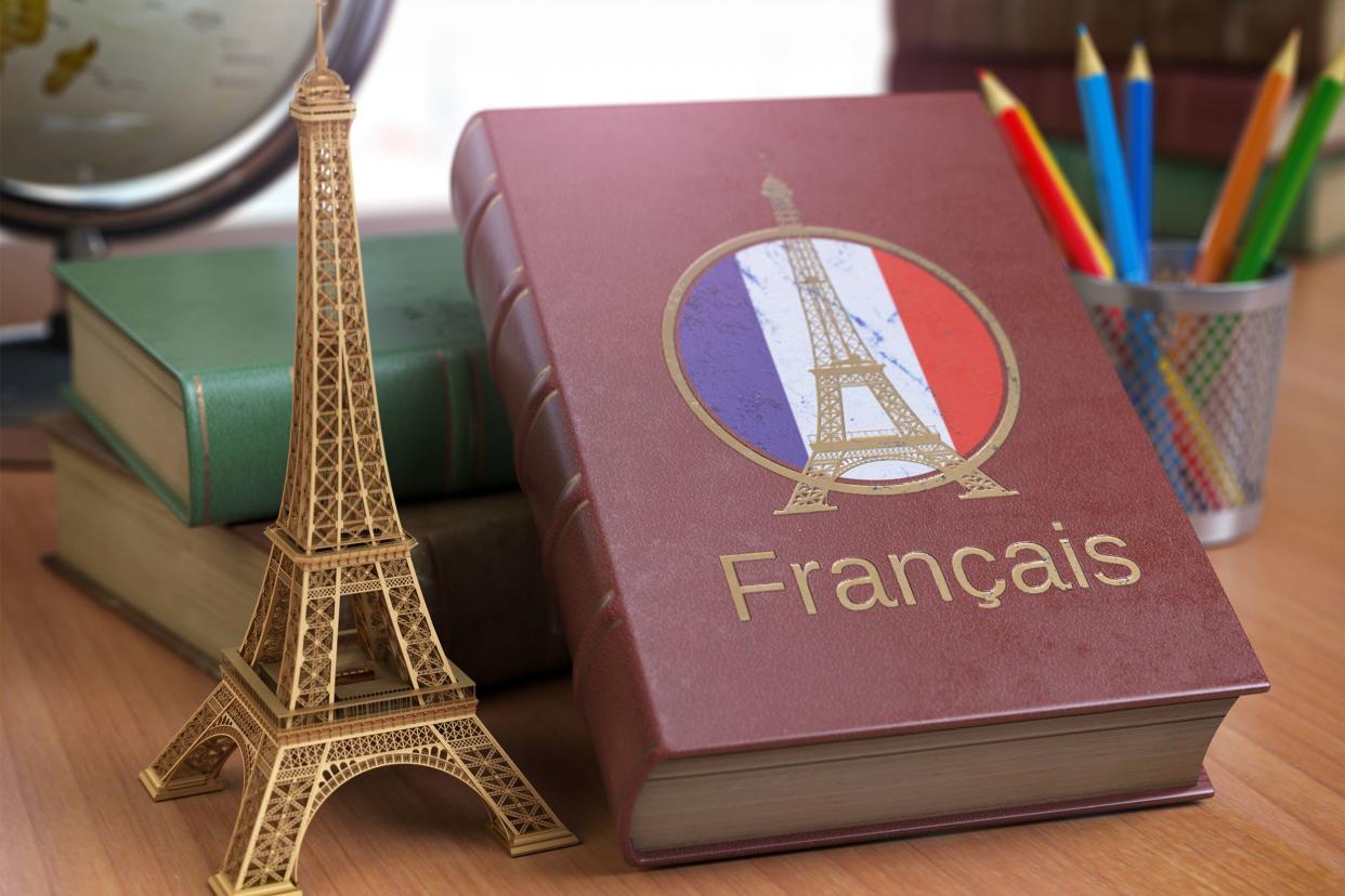 French learning book with a miniature Eiffel Tower