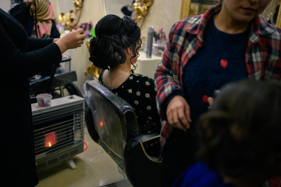 A woman has her hair done in a beauty salon in Kabul, Afghanistan, before her wedding party, in a December 15, 2022 file photo. / Credit: Elise Blanchard/The Washington Post/Getty