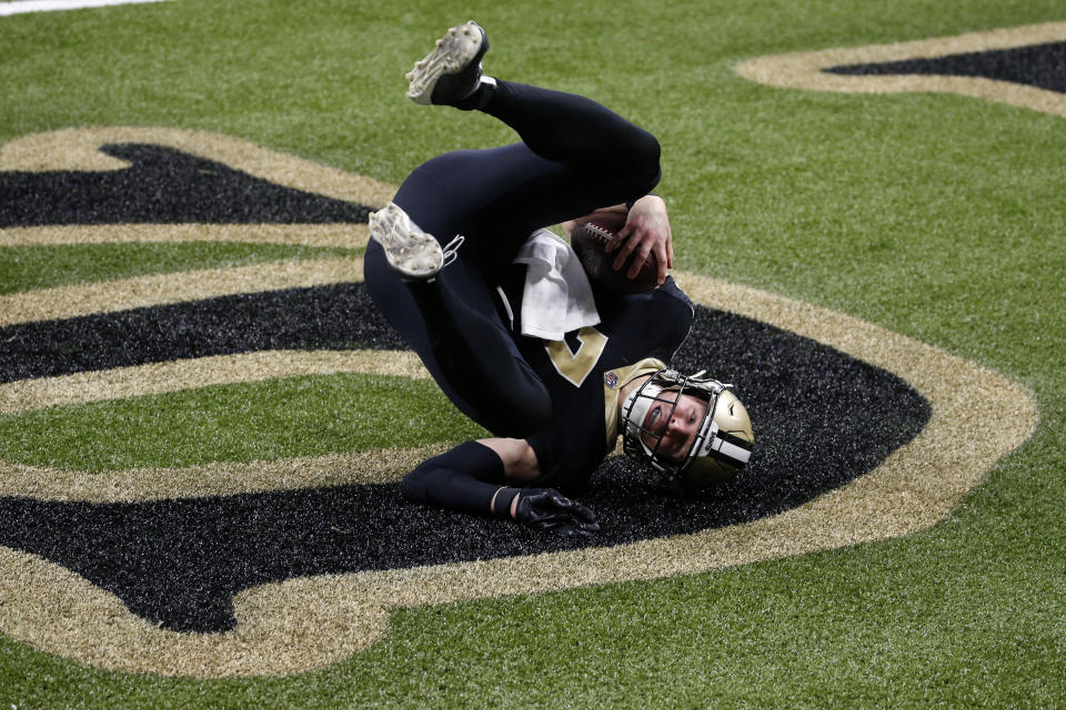 New Orleans Saints quarterback Taysom Hill (7) rolls into the end zone on a touchdown carry in the second half of an NFL football game against the Los Angeles Chargers in New Orleans, Monday, Oct. 12, 2020. (AP Photo/Butch Dill)