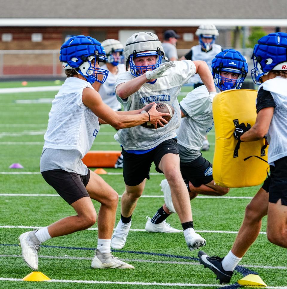 Brookfield Central quarterback Mason Medved gives a handoff to running back Jack Lortscher during the first day of high school football practice on Tuesday, August 1, 2023. (Syndication: Journal Sentinel)